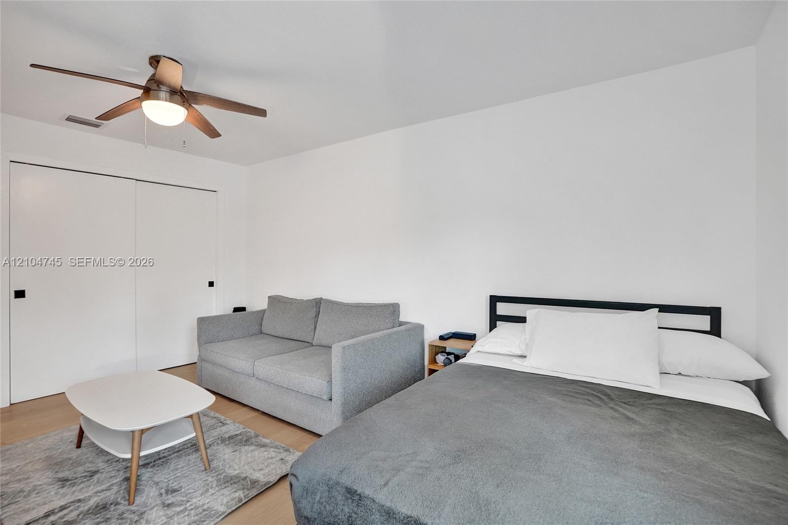 Wood-finish flooring with a ceiling fan light fixture