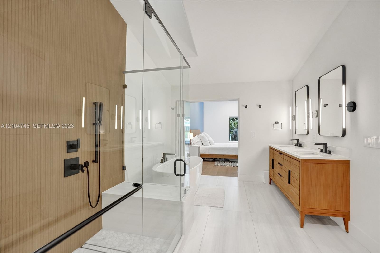 Dual vanity with rectangular sinks, wood-finish cabinetry, and matte black fixtures