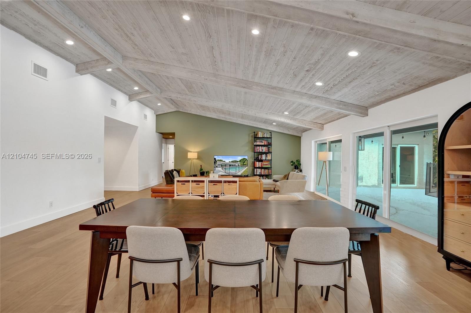 Vaulted ceiling with exposed beams and recessed lighting
