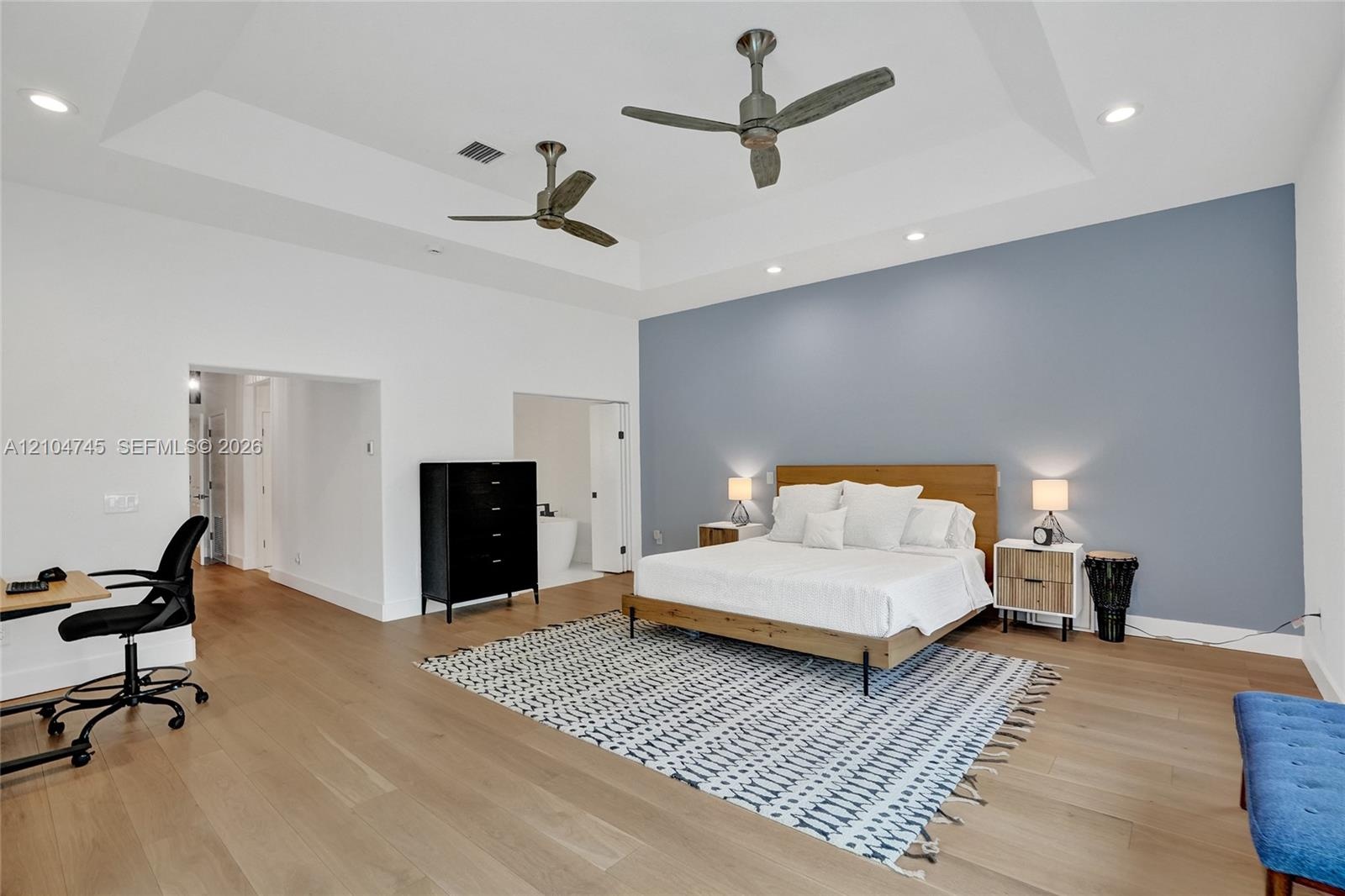 Tray ceiling with recessed lighting and two ceiling fans