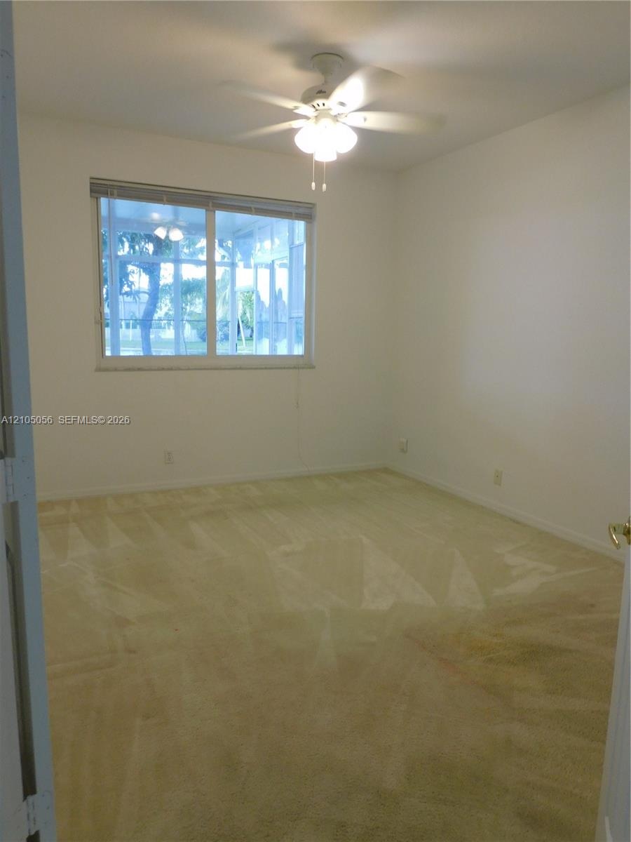 Practicability of a full bedroom one bath downstairs, ceiling fan, dual bi-fold panel doors, and double French doors opening to tile flooring