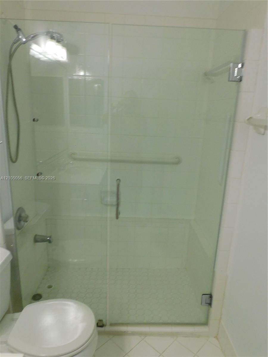 Downstairs Full Bathroom with White vanity with integrated sink, chrome faucet, and overhead lighting