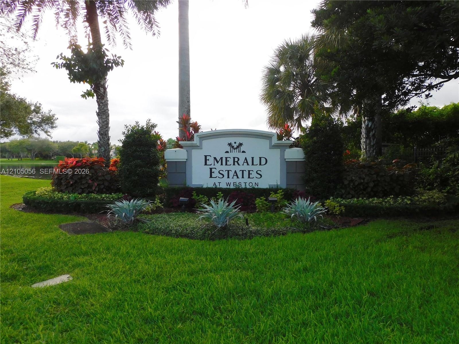 Emerald Estates at Weston signage featuring white columns and dark lettering