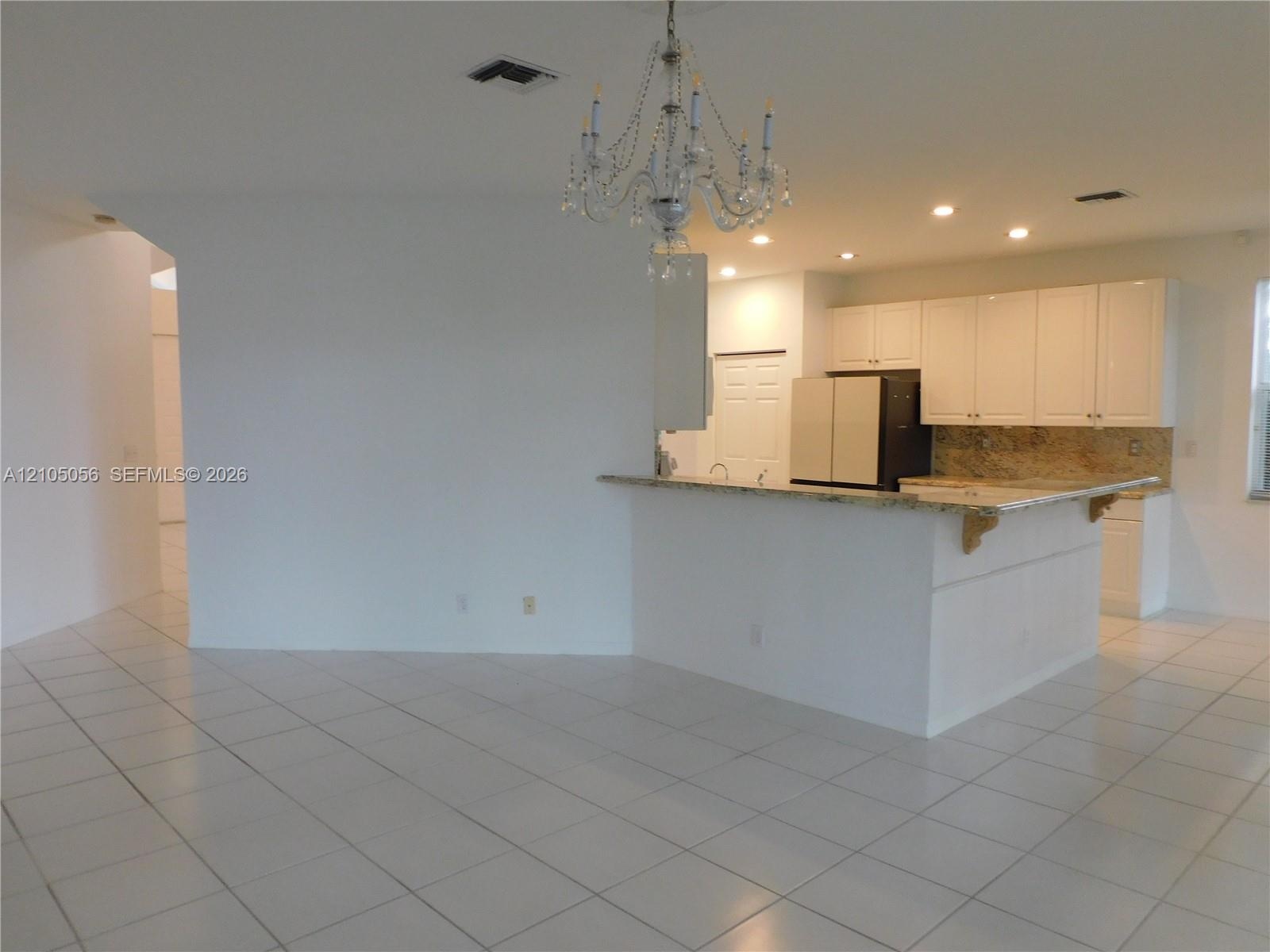 View from breakfast area to family room - plenty of wall space for a large TV - perfect for game days with family and friends.