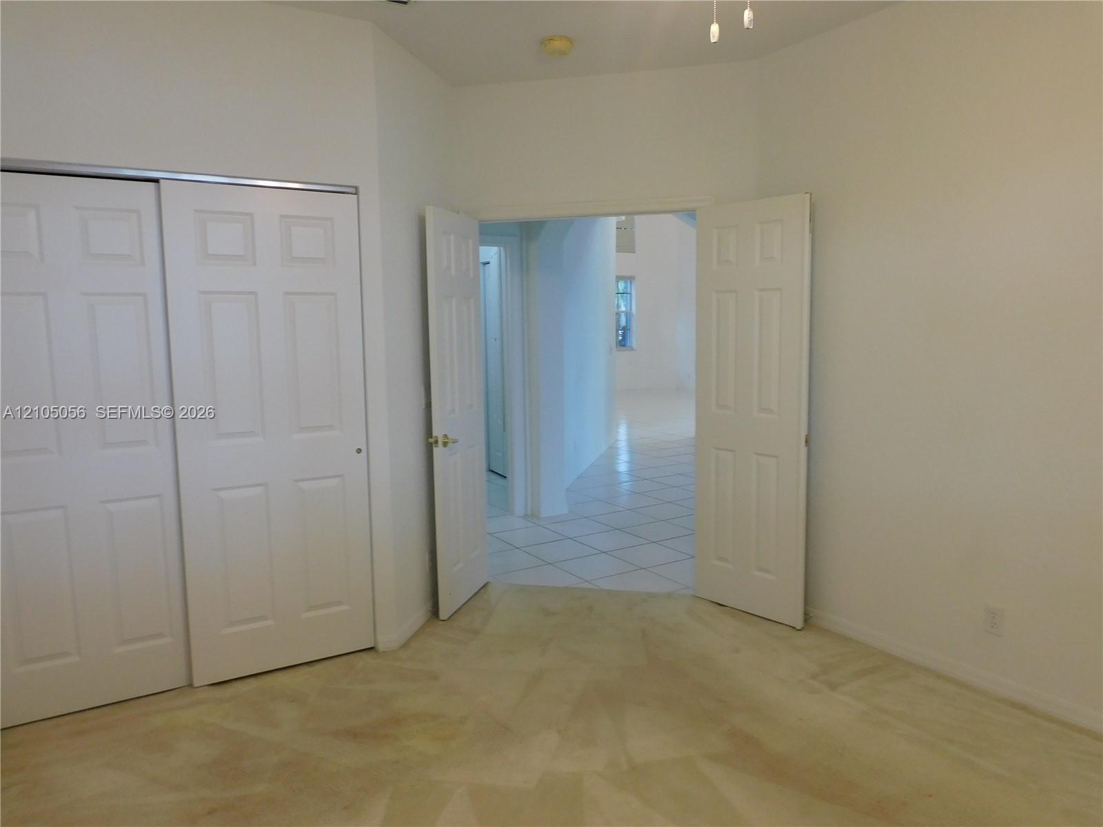 Kitchen featuring light-toned cabinetry, granite countertops, pantry and plenty of cabinet space.