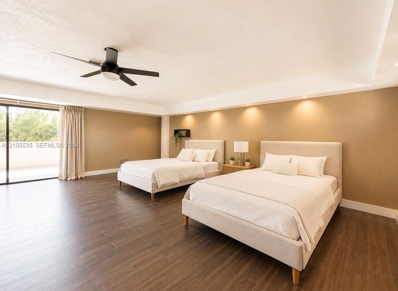 Spacious room featuring wood-finish flooring, recessed lighting, a modern ceiling fan, and sliding glass doors opening to an outdoor area