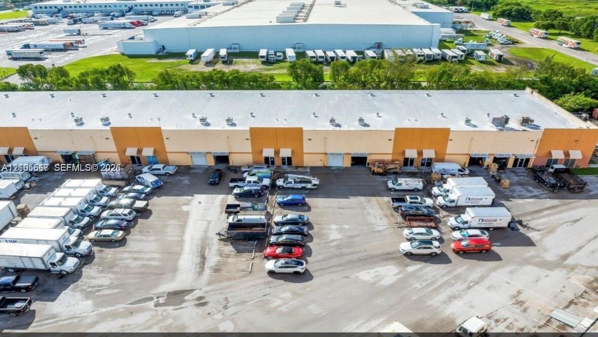 Industrial building featuring multiple bay doors and a large paved lot