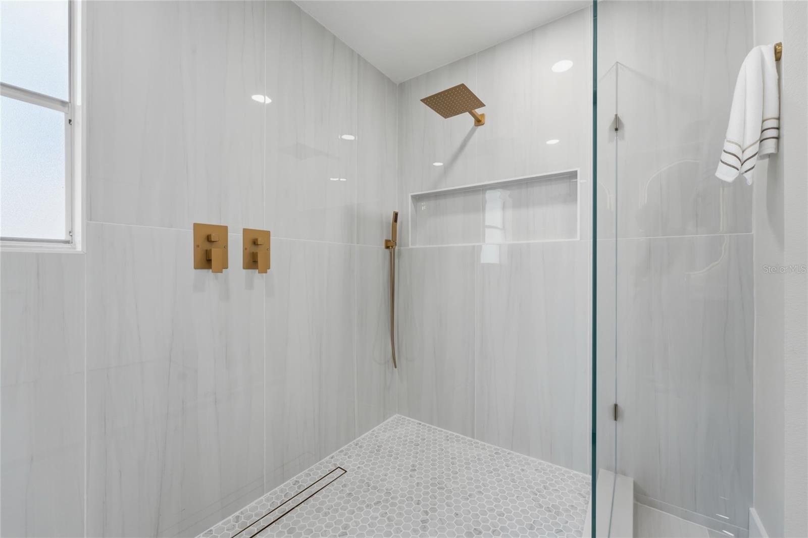 Porcelain tile shower featuring a custom-designed wall niche