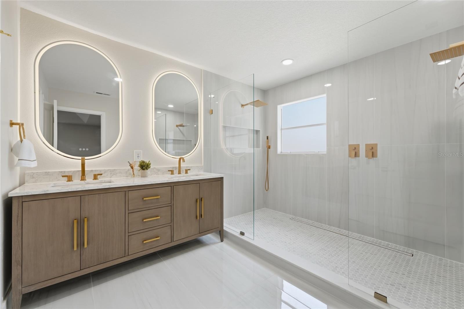Master spa featuring double vanity with marblecountertop