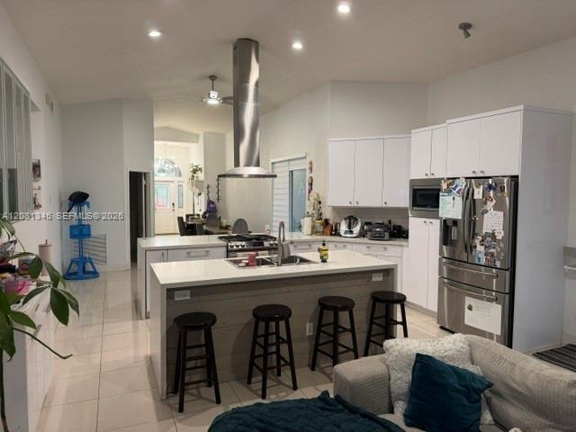 Vaulted ceilings, recessed lighting, and stainless steel appliances