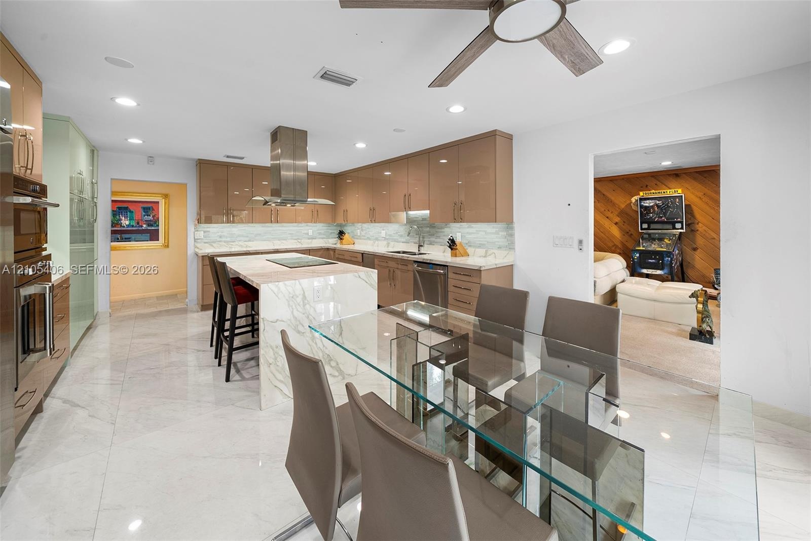 Kitchen featuring a waterfall island, integrated stainless steel appliances, contemporary cabinetry, a tile backsplash, and recessed lighting
