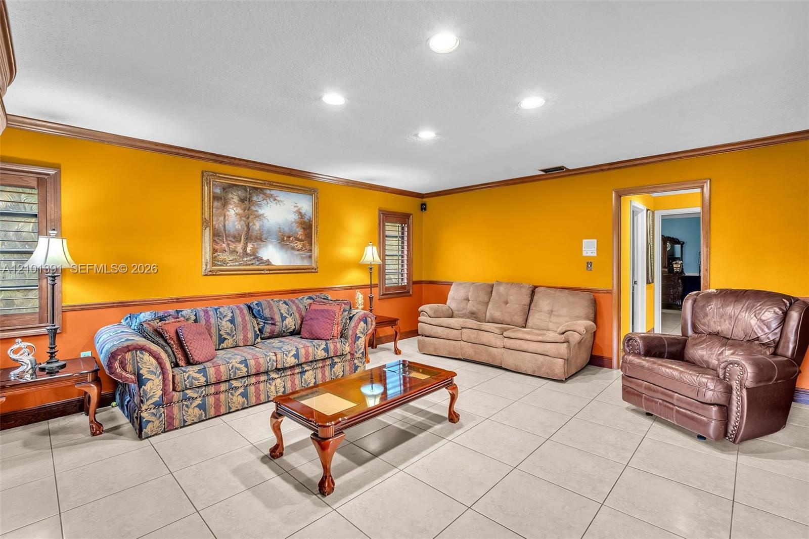 Recessed ceiling lighting, tile flooring, and decorative wood trim