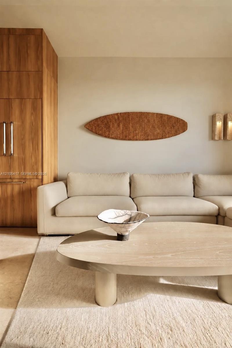 Built-in wood-finish cabinetry, neutral wall color, and wall-mounted sconces