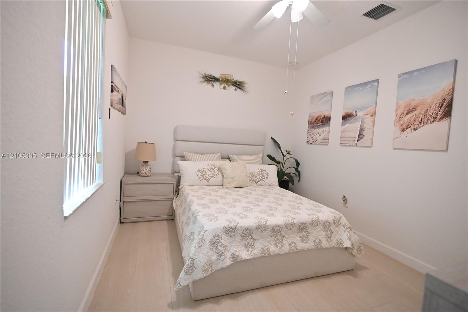 White interior walls complemented by wood-finish flooring