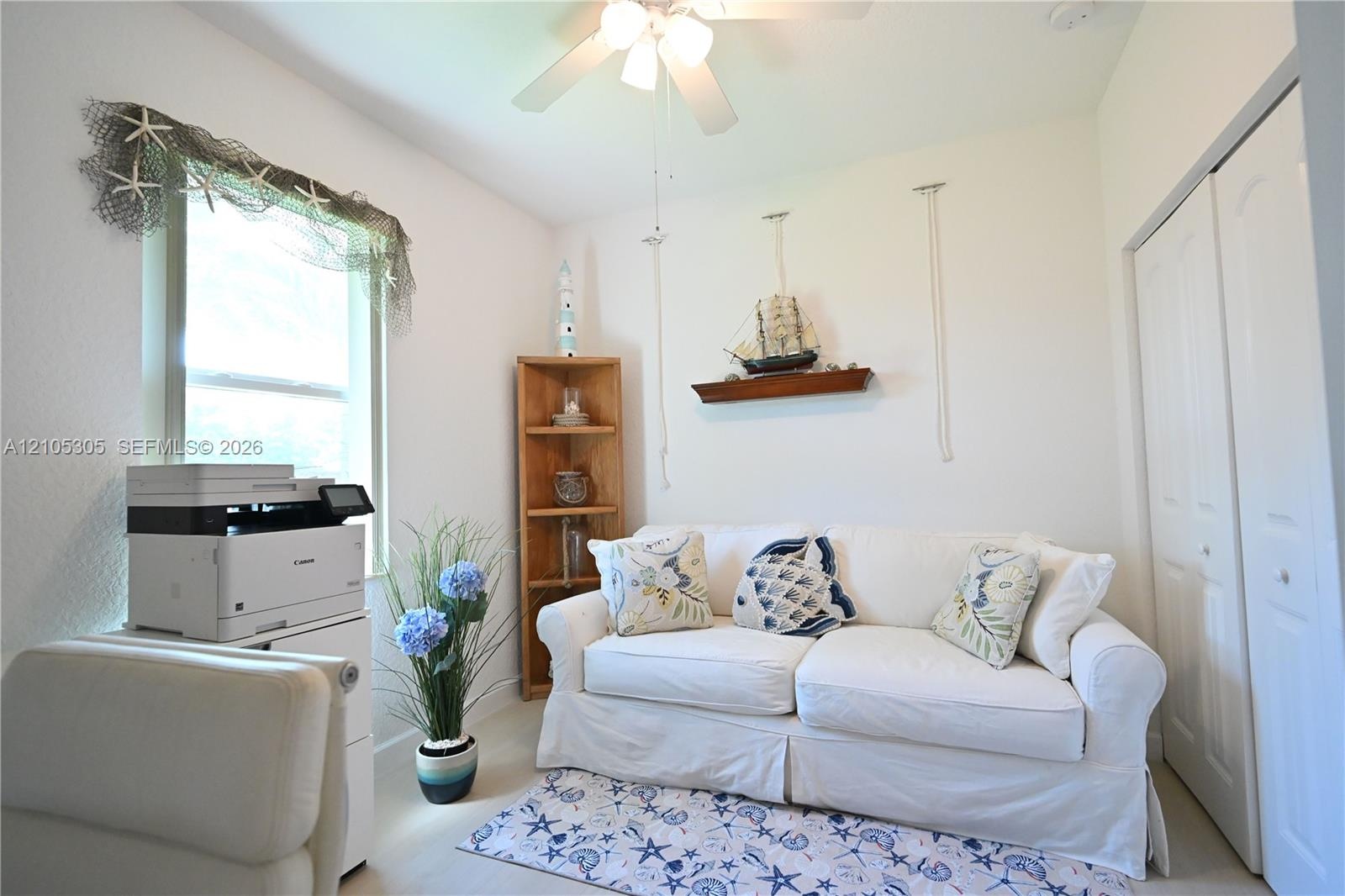 White walls, light-toned flooring, and a ceiling fan