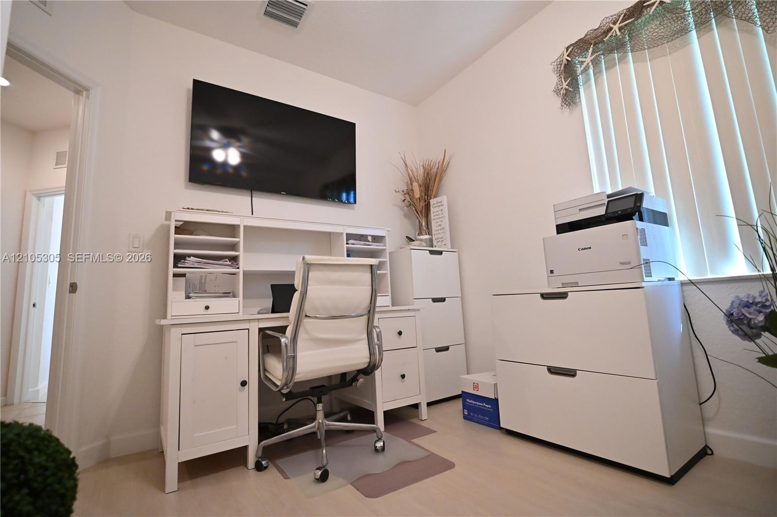 White wall finishes with light wood-finish flooring