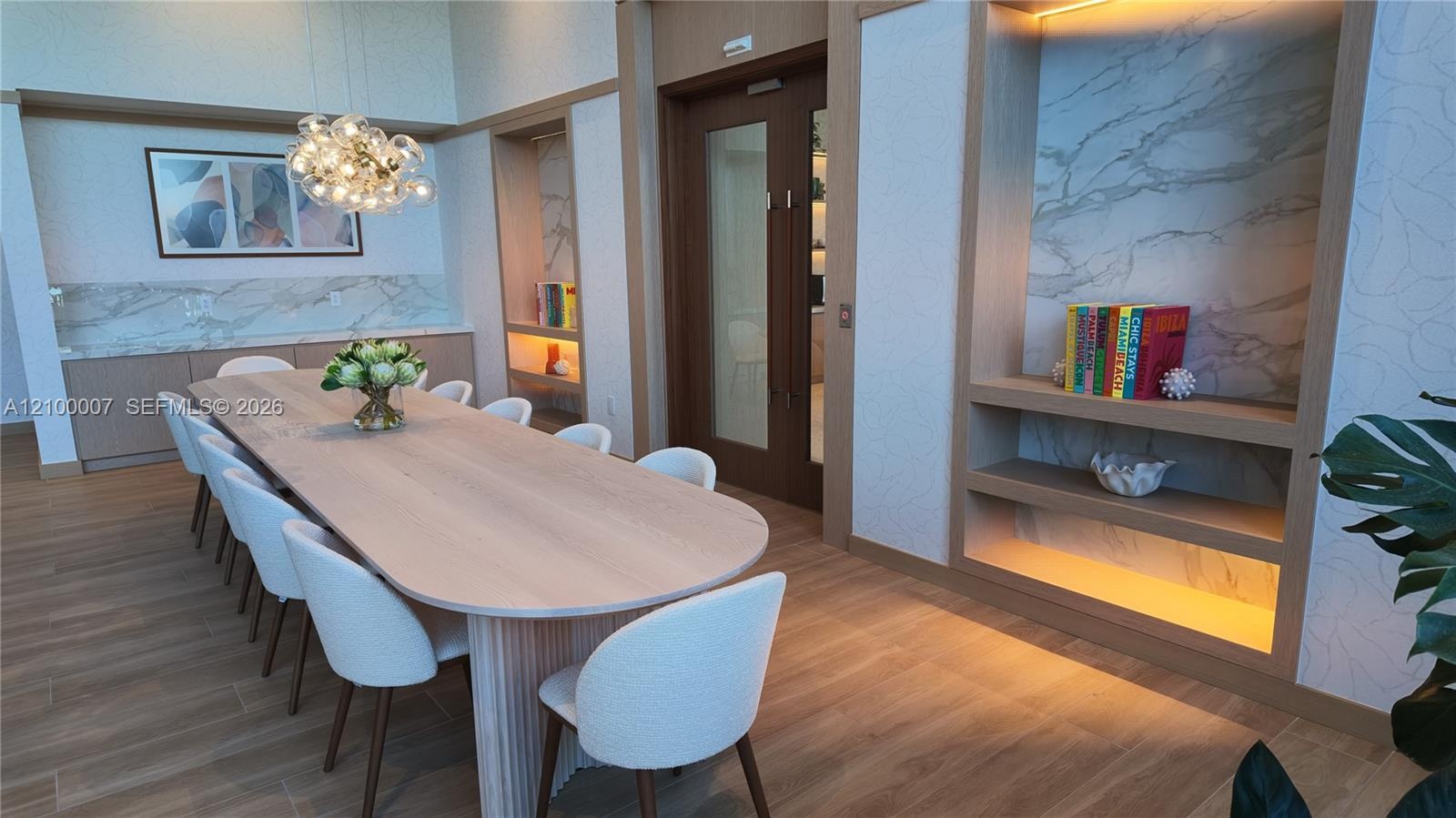 Wood-finish flooring, built-in cabinetry with stone countertop and backsplash, modern chandelier, built-in shelving with accent lighting, and a wood-p