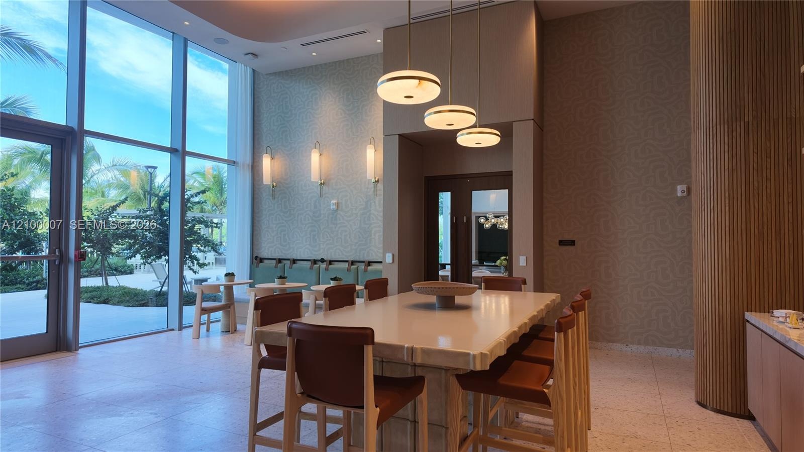 Expansive floor-to-ceiling windows, patterned accent wall, recessed lighting, modern pendant lighting, and wood-slat wall paneling