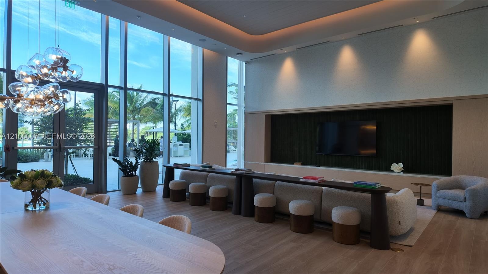 Spacious room featuring floor-to-ceiling windows, recessed lighting, and wood-finish flooring