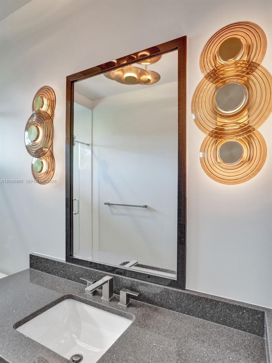 Walk-in closet featuring dark wood-grain cabinetry, floor-to-ceiling adjustable shelving, integrated hanging rods, built-in dresser drawers with matte