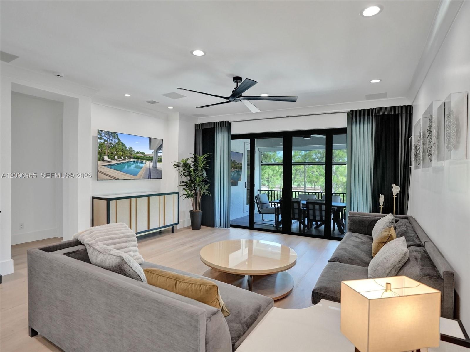 Open-concept interior featuring a central island with a white quartz countertop, matte black faucet, and integrated sink