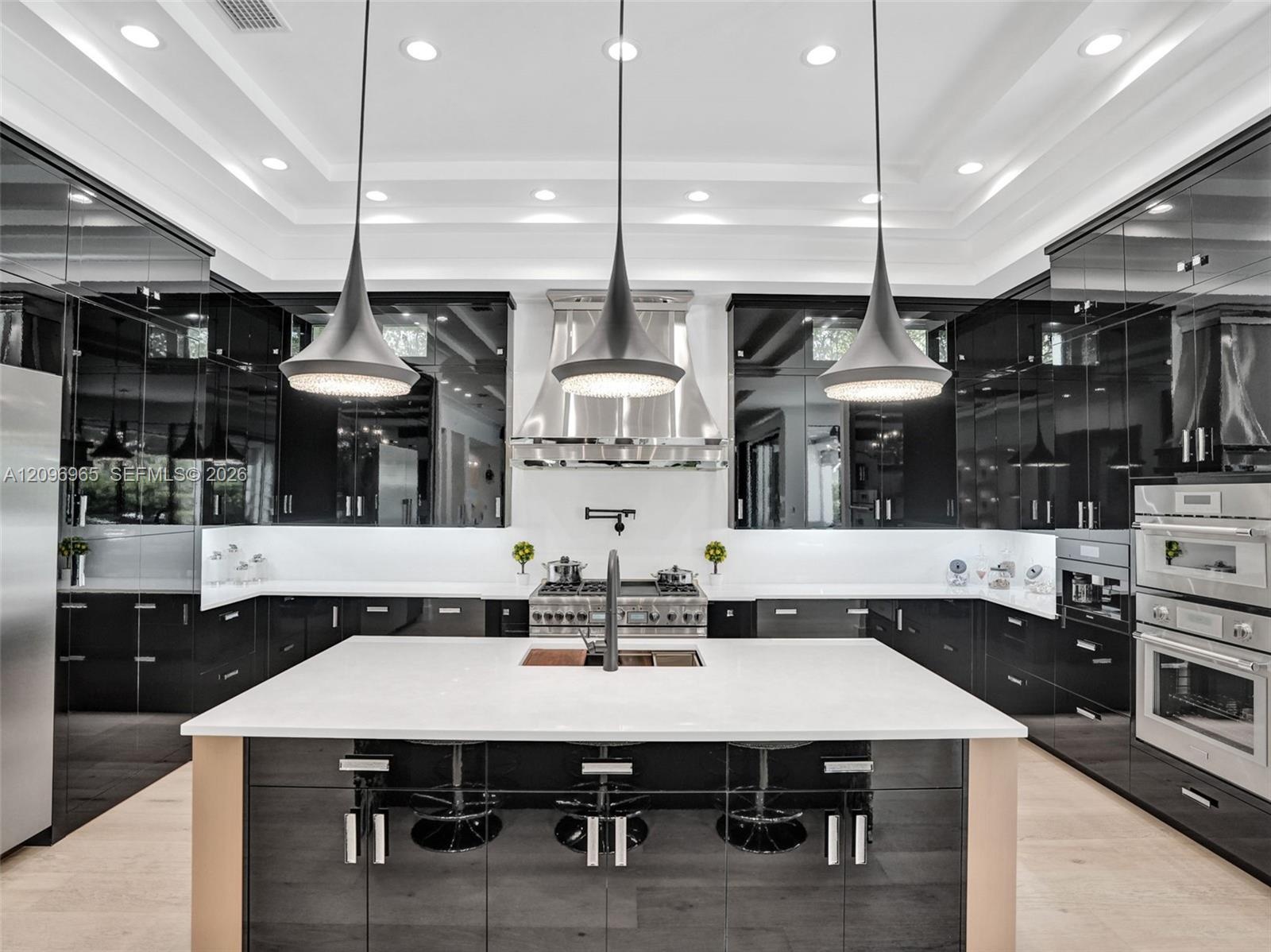 Custom wine cellar featuring horizontal metal racking, high-gloss cabinetry, linear pendant lighting, and a white countertop