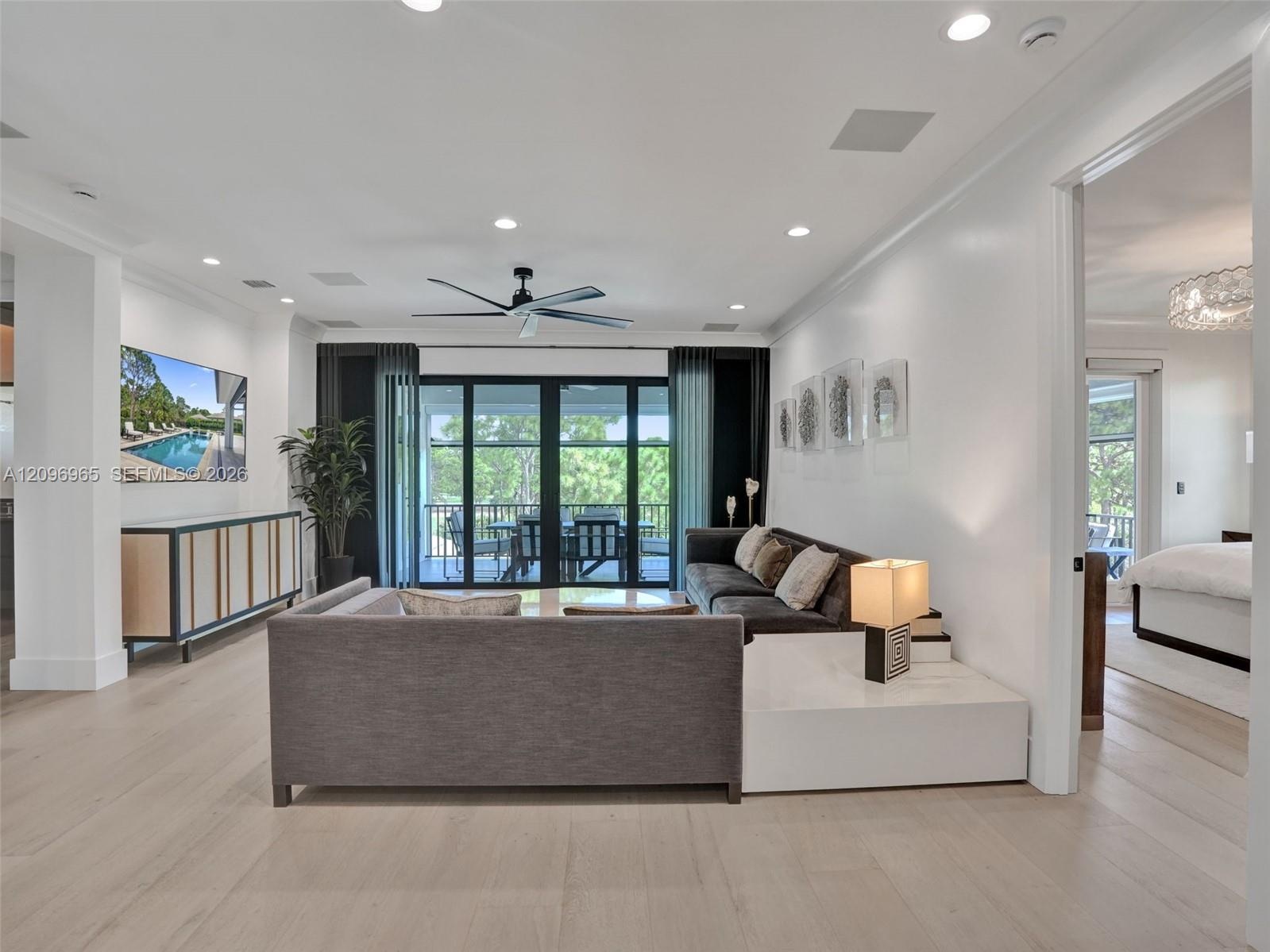 High-gloss black cabinetry, professional-grade stainless steel range with a custom hood, quartz countertops, built-in double wall ovens, and wood-fini