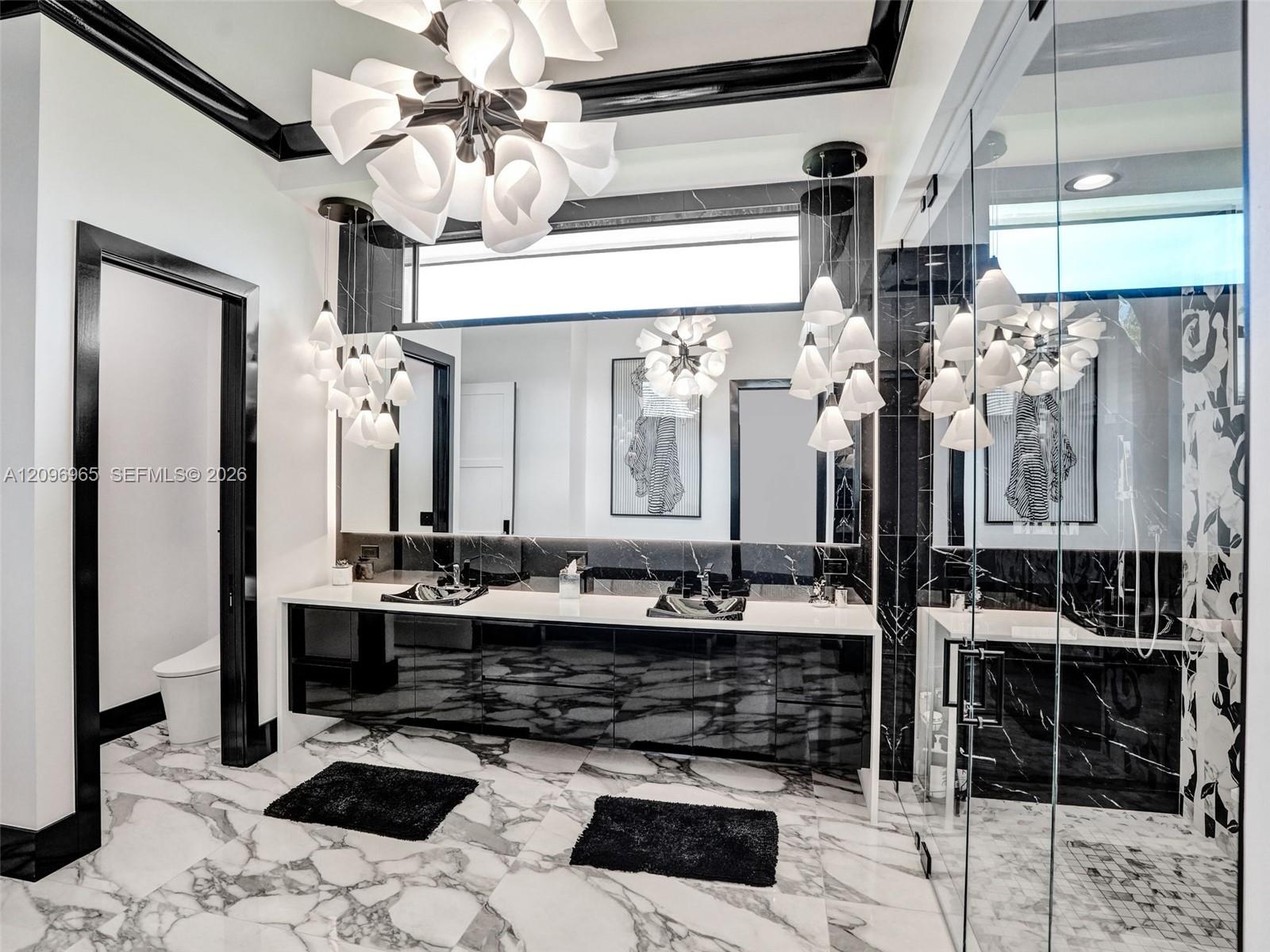 Polished high-contrast black and white stone surfacing featuring a bold brecciated pattern, set against light-toned wood-finish flooring