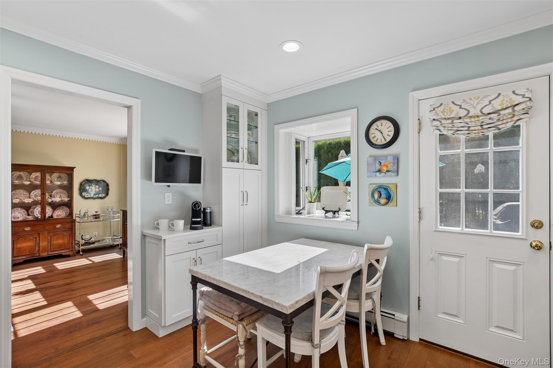 Custom cabinets by Ken Kelly Inc. paired with sleek quartz countertops and stainless steel appliances make this a showstopper!