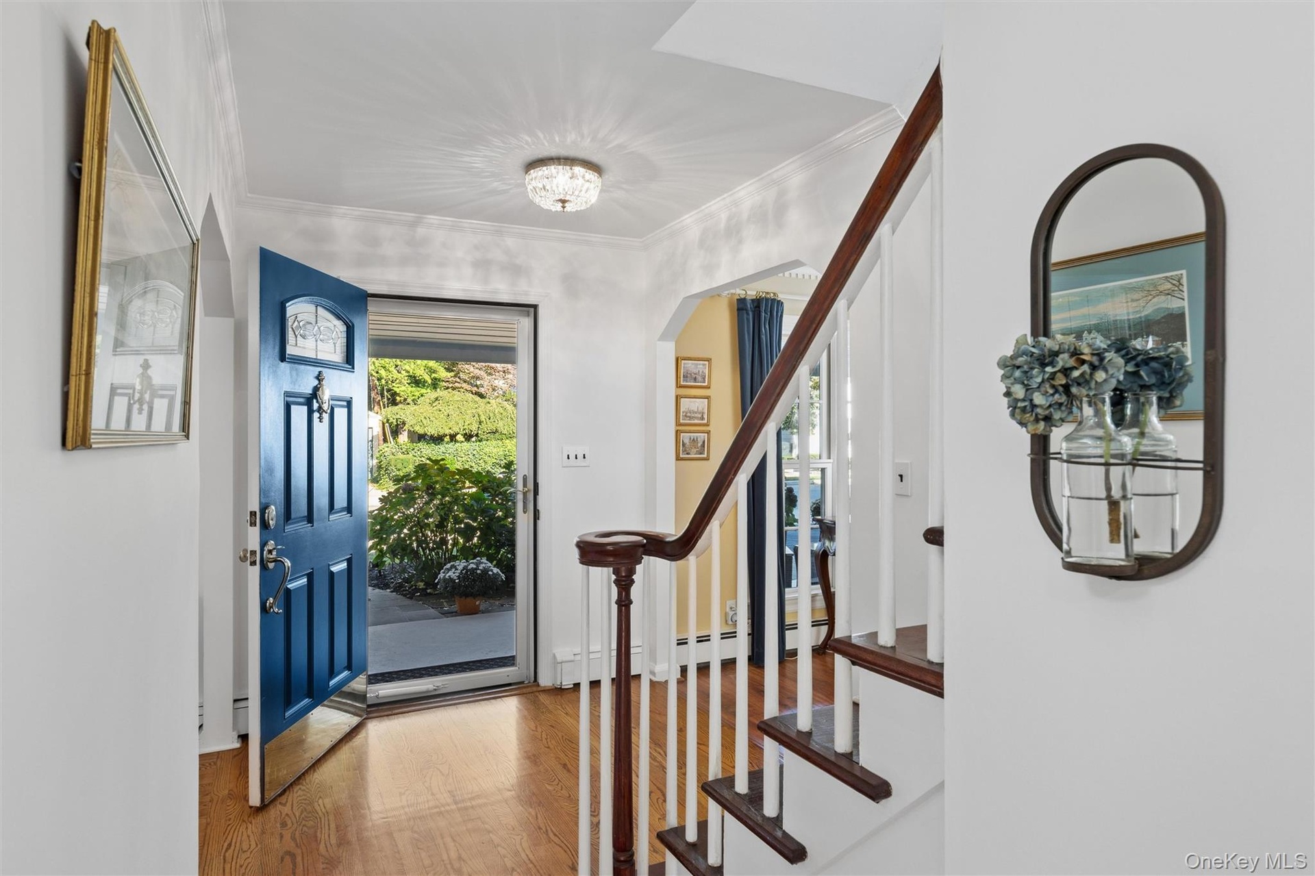 Entry foyer is warmed by hardwood floors & natural light from 2nd floor landing
