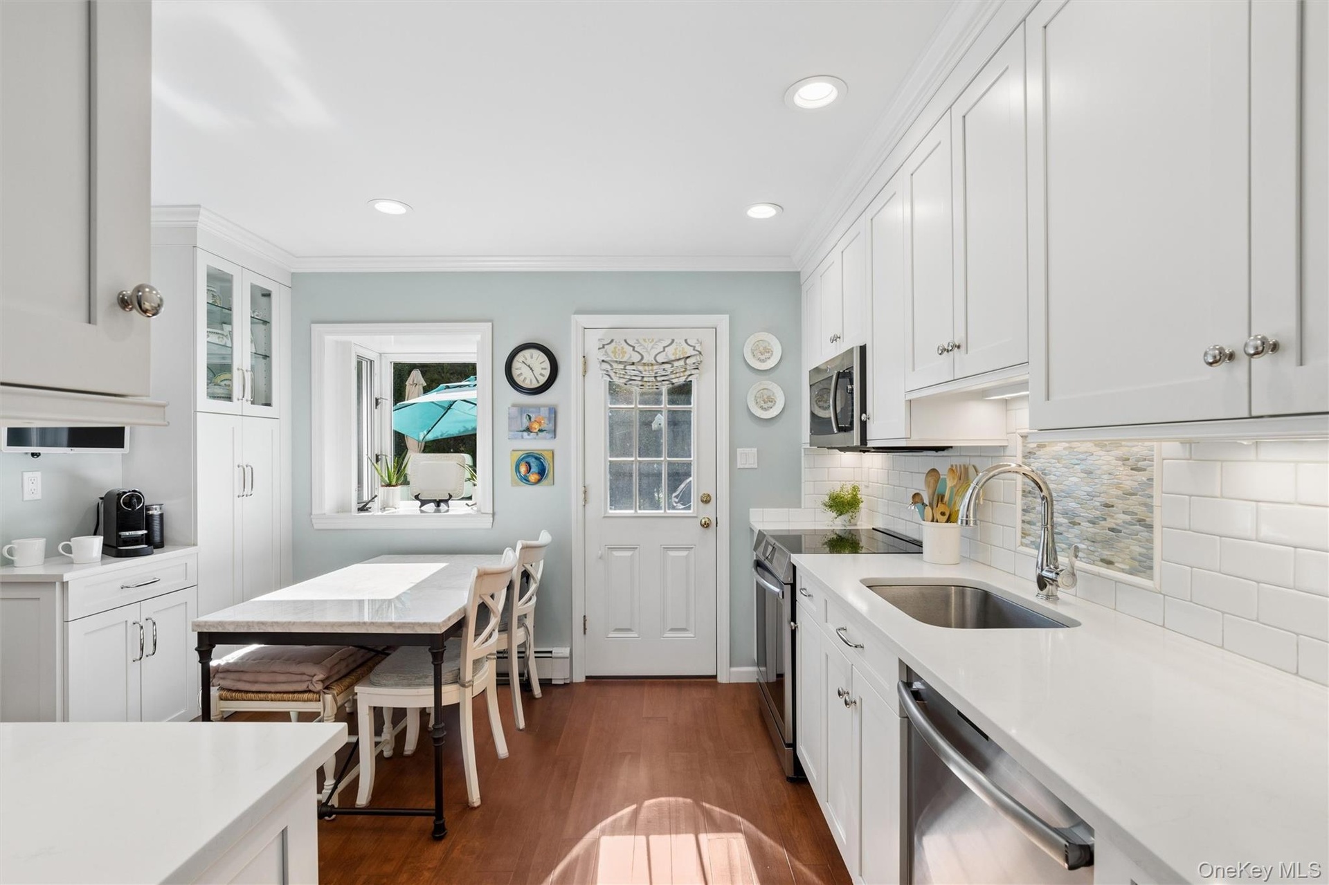 The heart of the home is the stunning 2014 eat -in kitchen with access to the entertaining patio