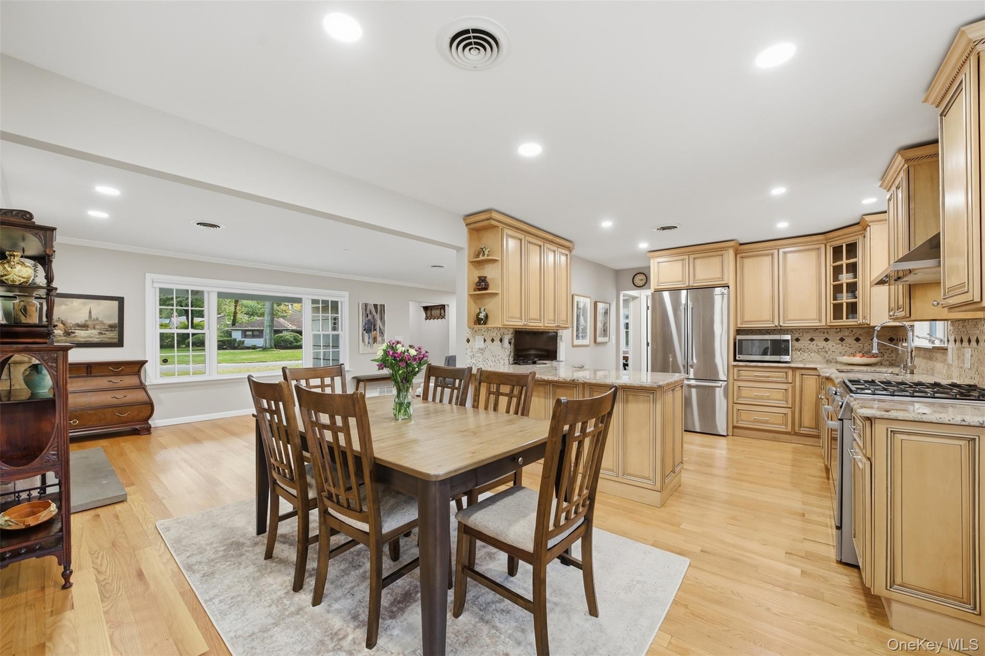 Open floor plan, dining into kitchen, dining into living room with fireplace