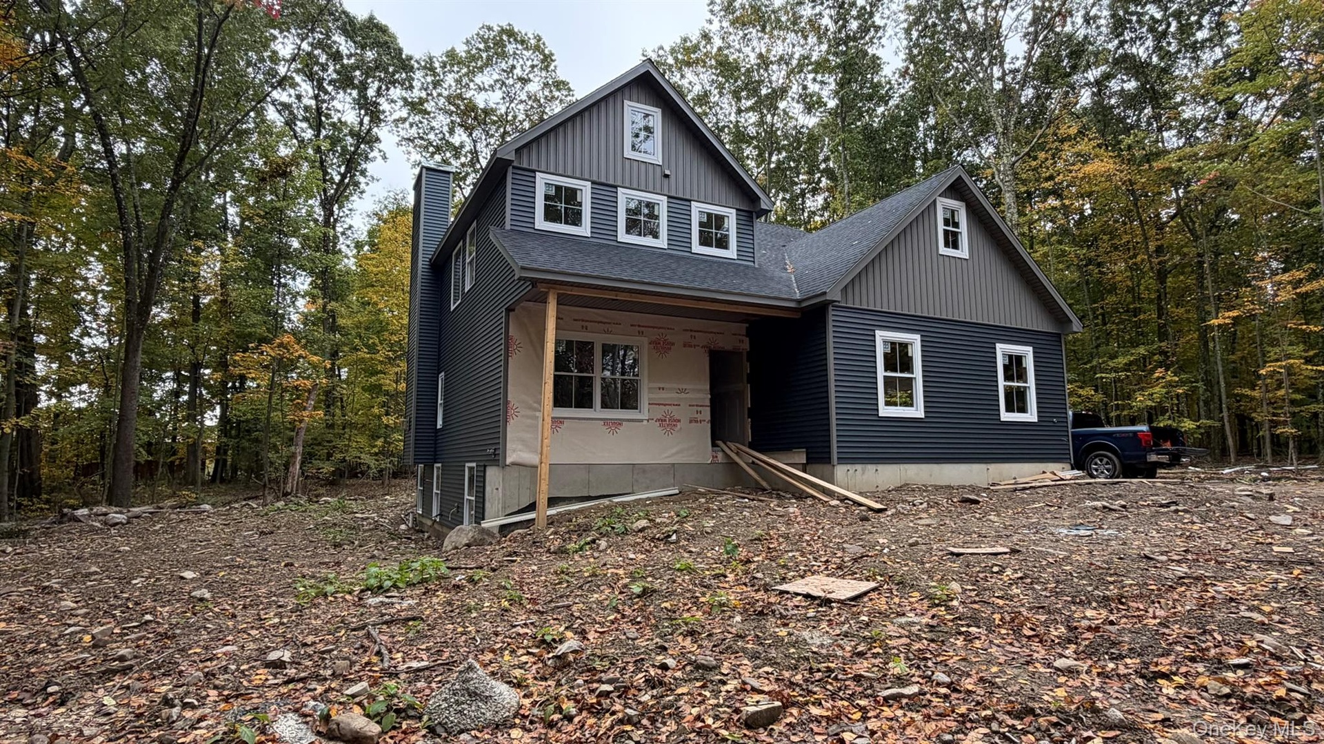 Construction Progress Photo of Exterior Siding Installation in Progress.