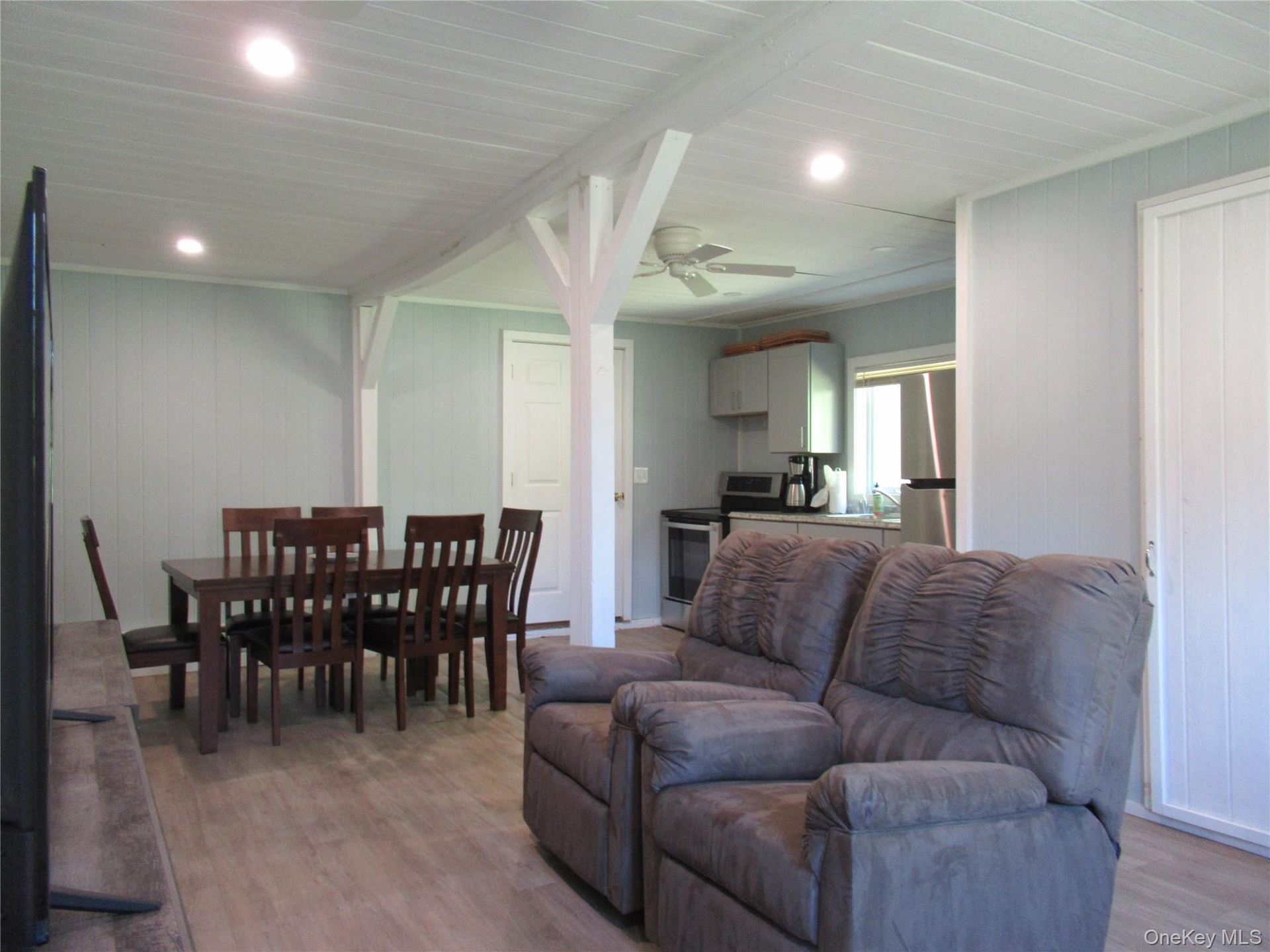 Open concept Living area with recessed lighting and ceiling fan
