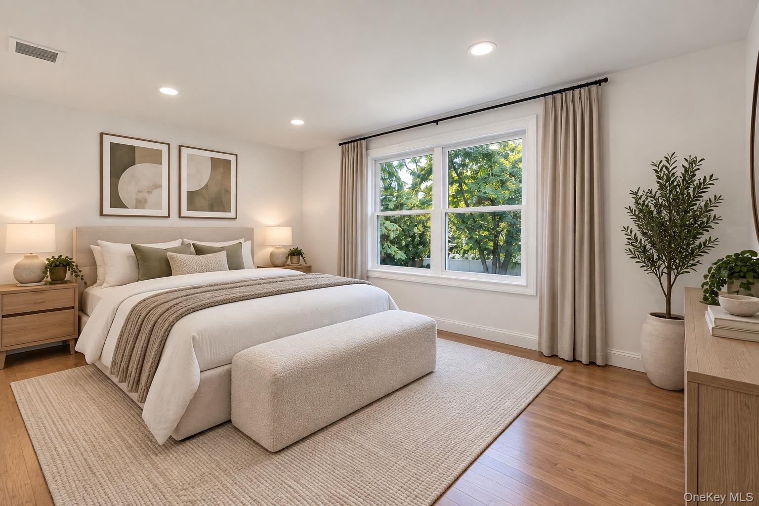 2nd floor Bedroom featuring wood-finish flooring, recessed lighting, and a large double-pane window with white trim