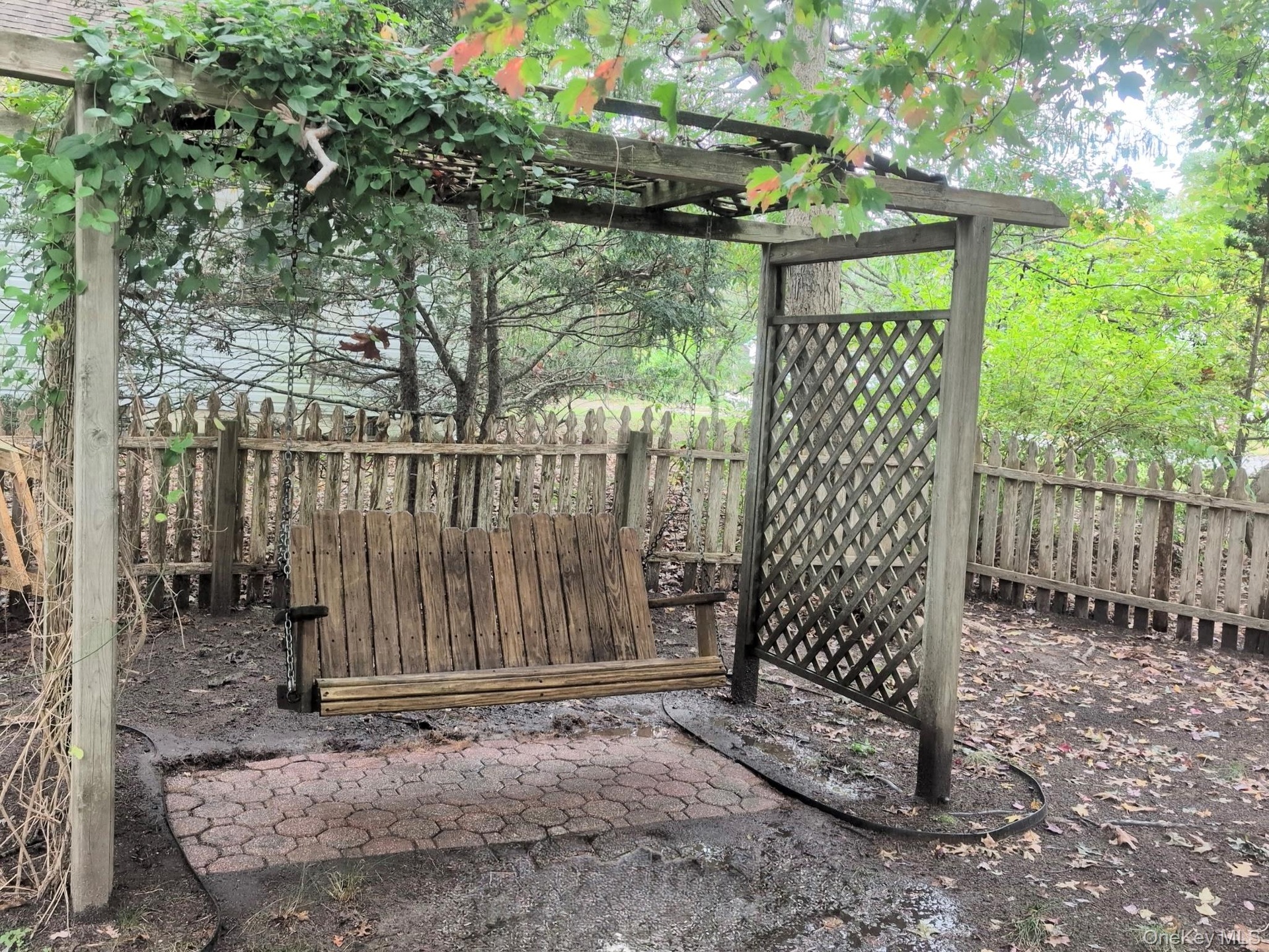 ...and an integrated hanging seat suspended over a hexagonal paver patio...