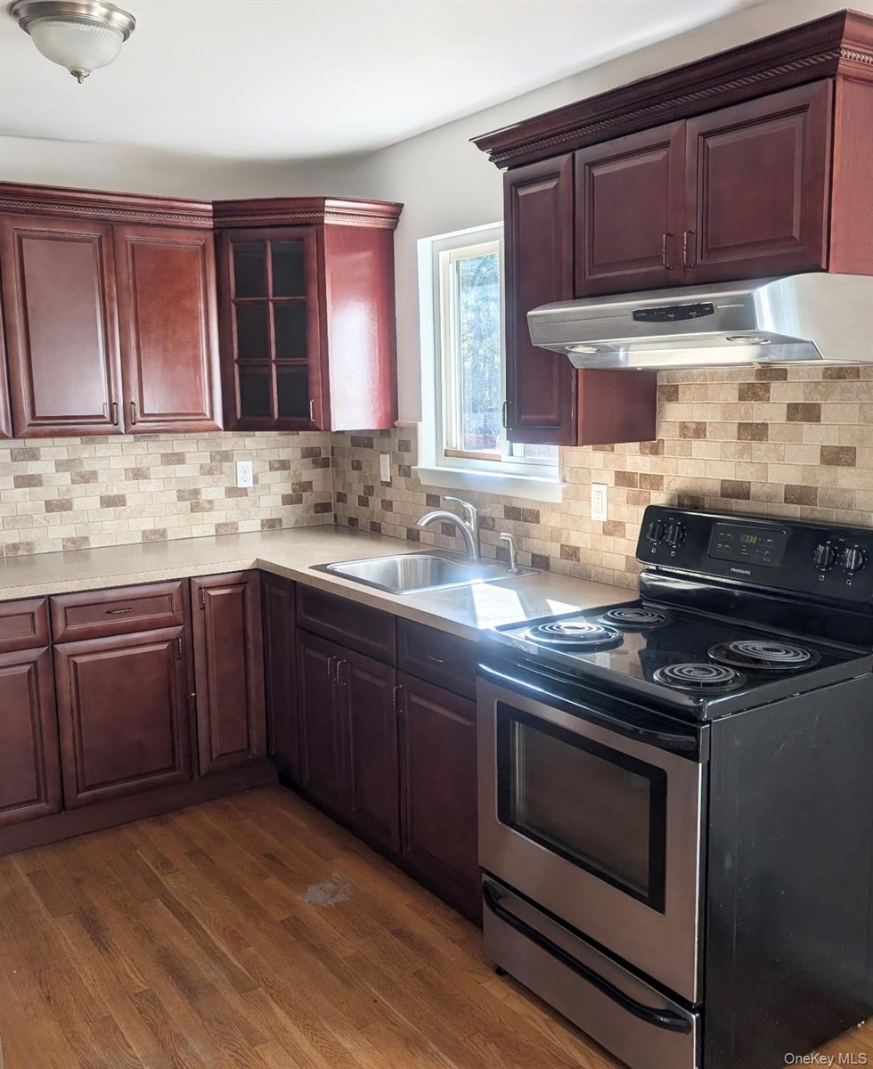 ...tile backsplash, solid-surface countertops, stainless steel undermount sink...