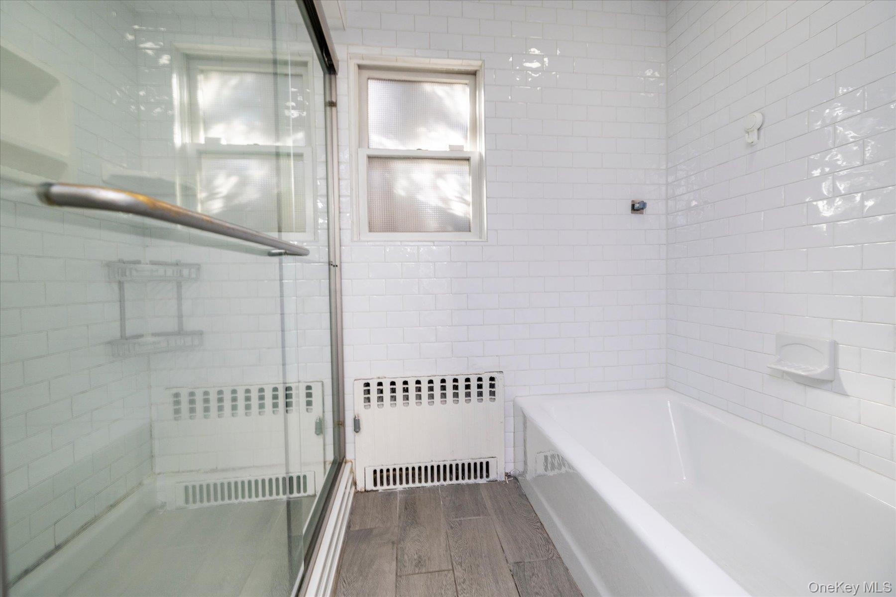 main floor bathroom featuring a tub and shower