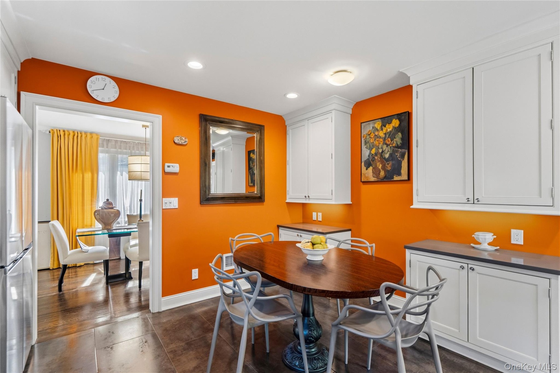 Kitchen featuring white custom cabinetry, neutral-toned solid surface countertops, recessed lighting, and large-format tile flooring