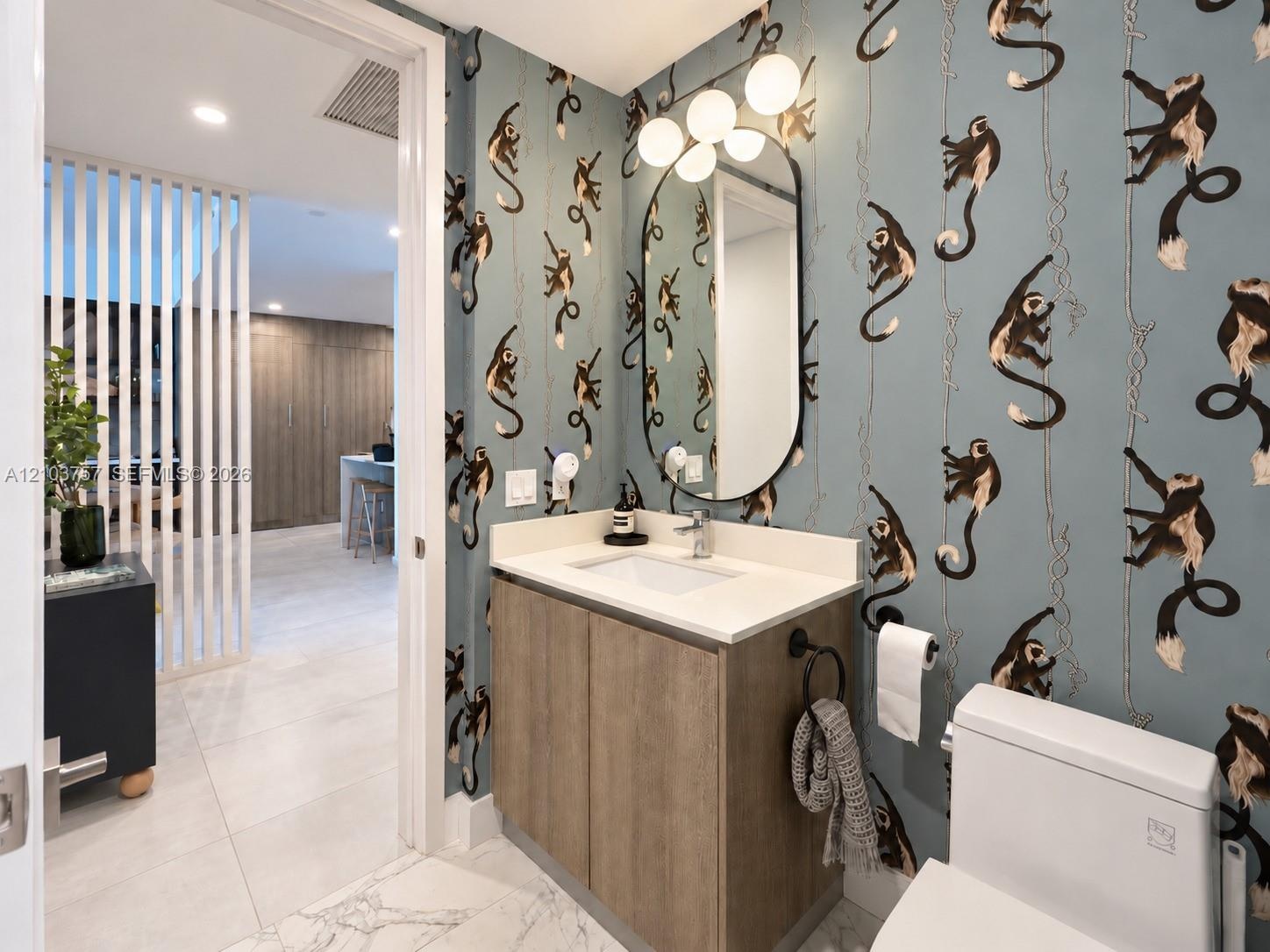 Powder room featuring a single vanity with a white countertop and wood-finish cabinetry