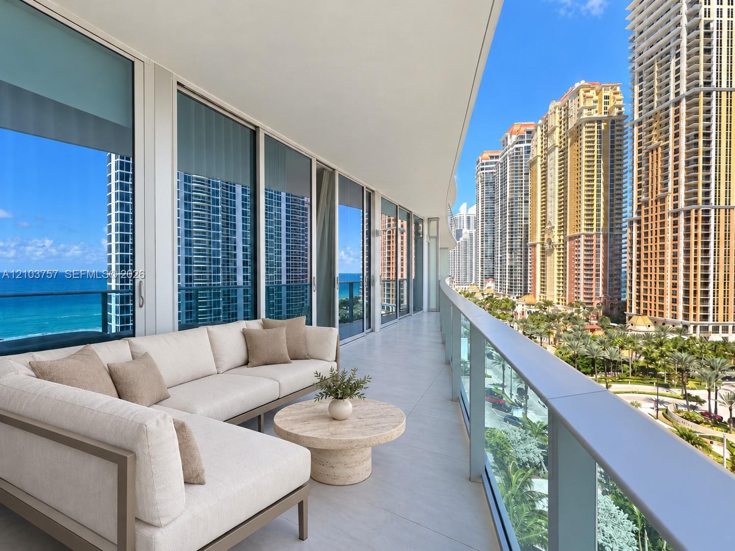 Expansive balcony featuring floor-to-ceiling sliding glass doors, a glass railing, and tiled flooring