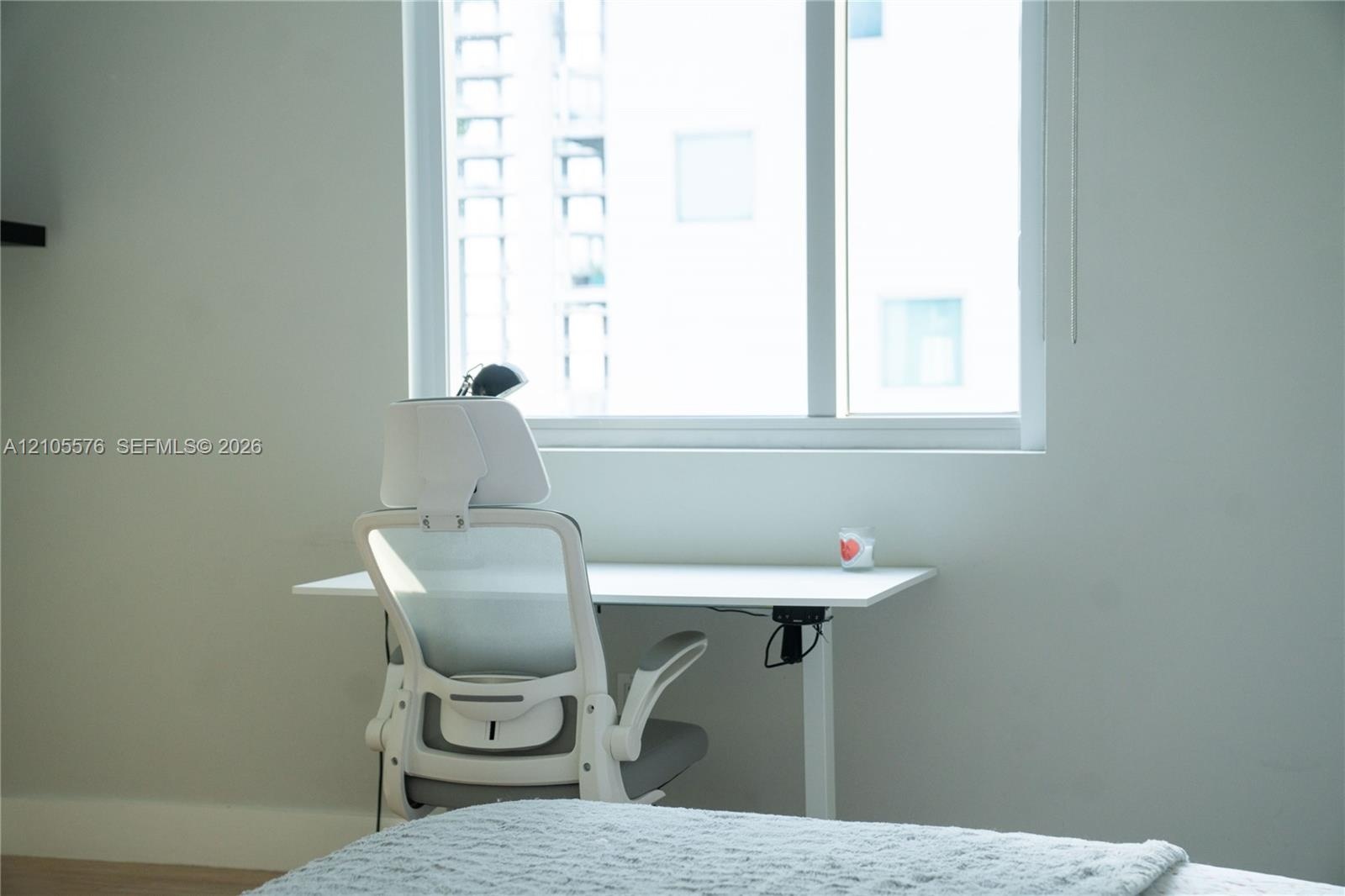 Large multi-pane window with a white frame and neutral wall finishes