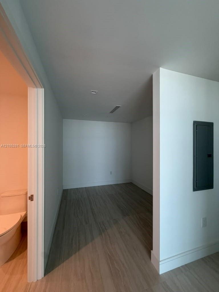 Interior space featuring wood-finish flooring, recessed ceiling lighting, and a neutral color palette