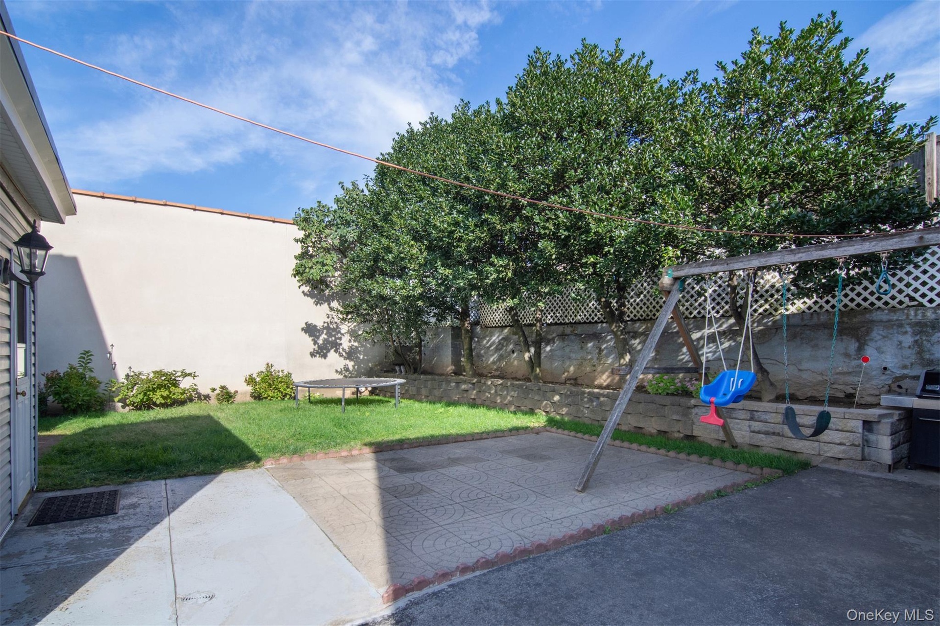 Level Private backyard with patio and play area