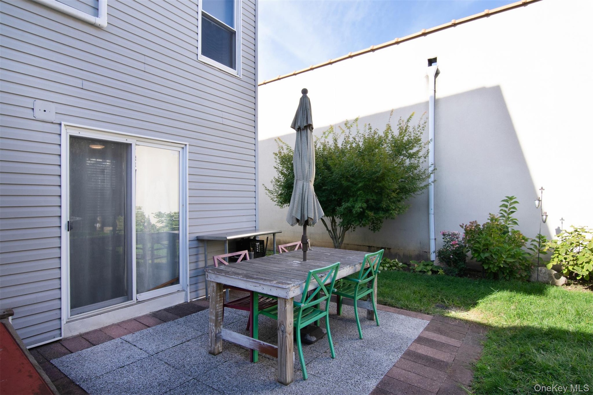 Patio area with sliding glass doors to house