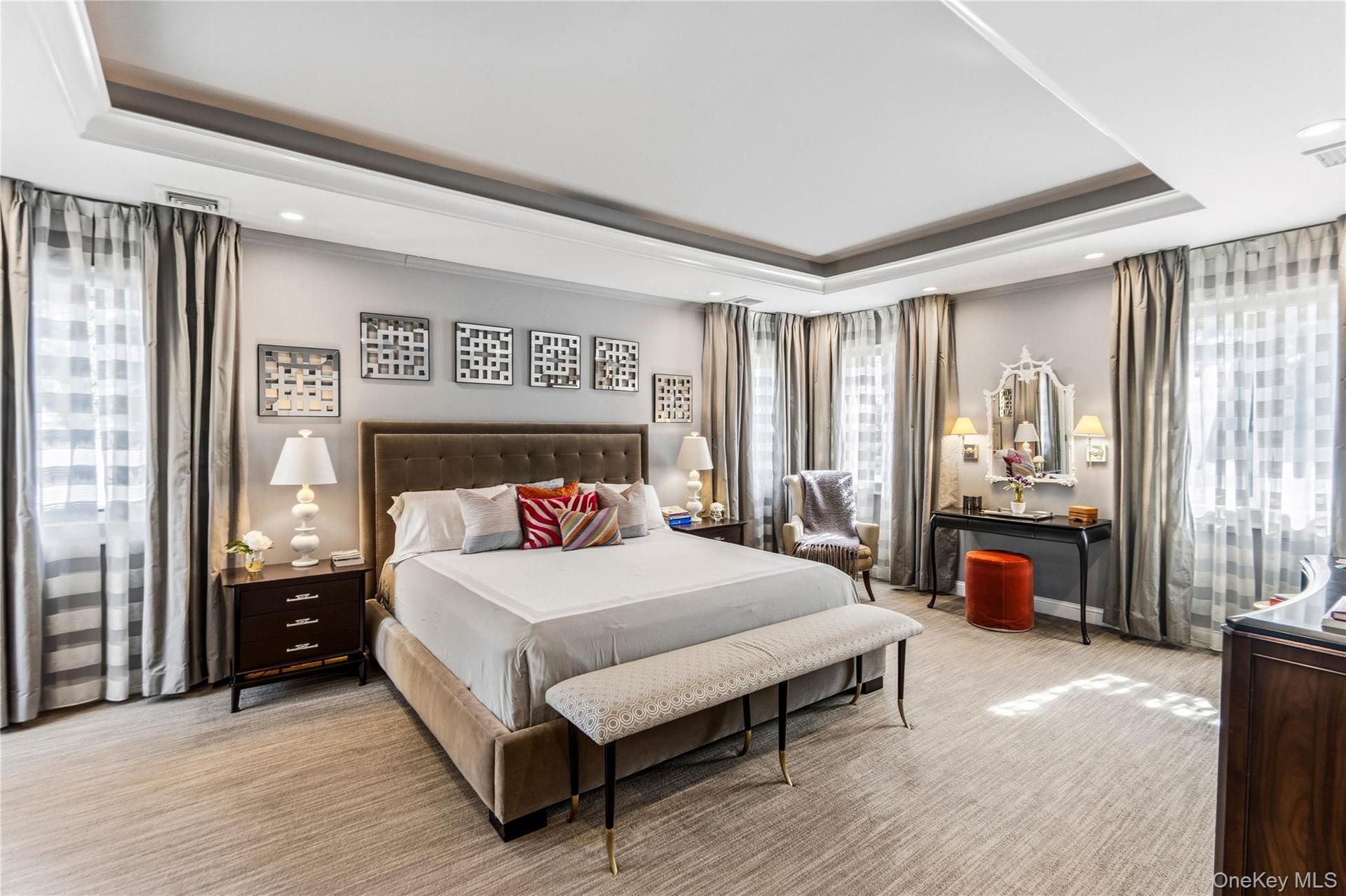 Tray ceiling with recessed lighting and neutral carpeting