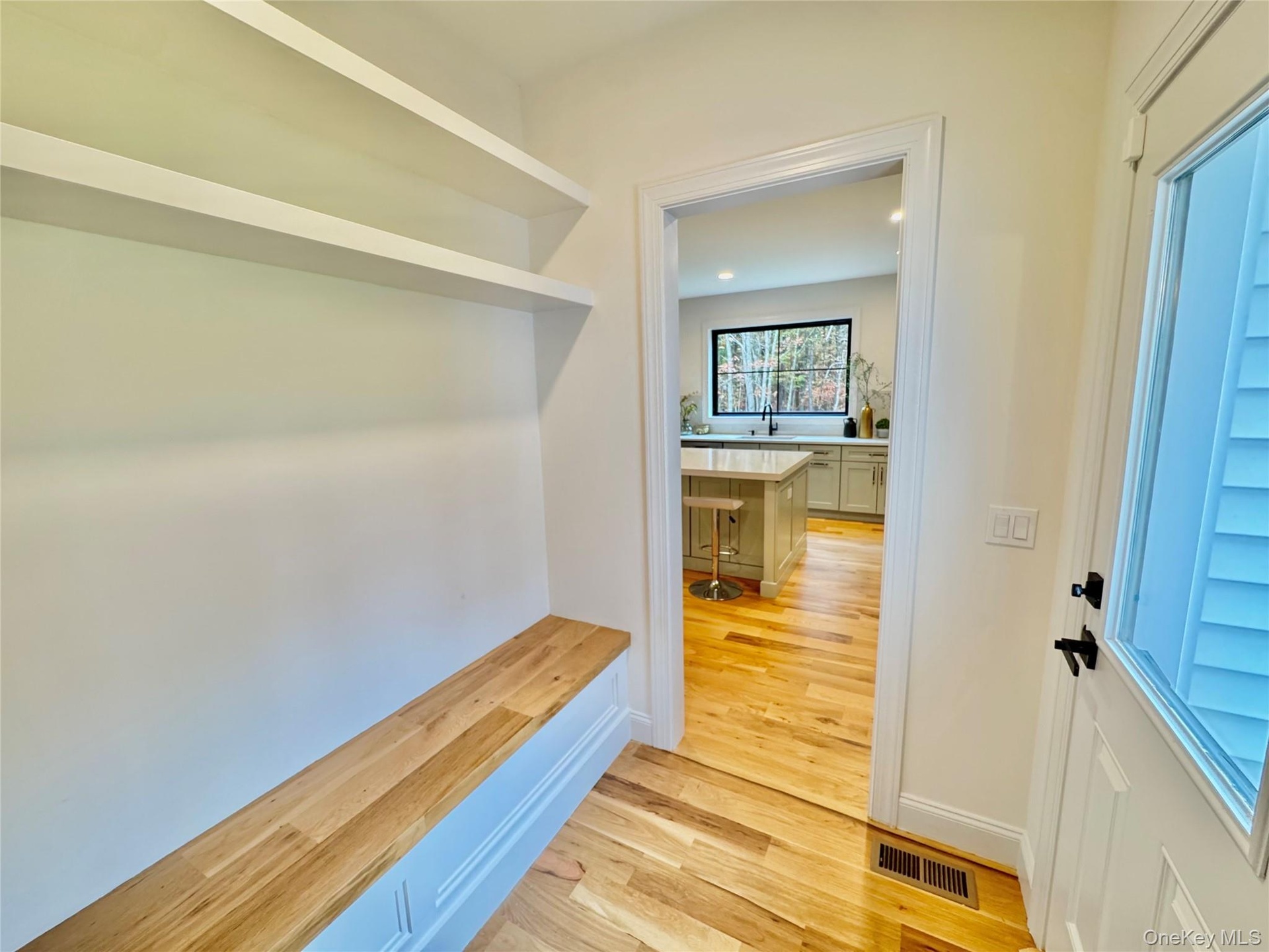 Mudroom featuring light wood-style floors and baseboards