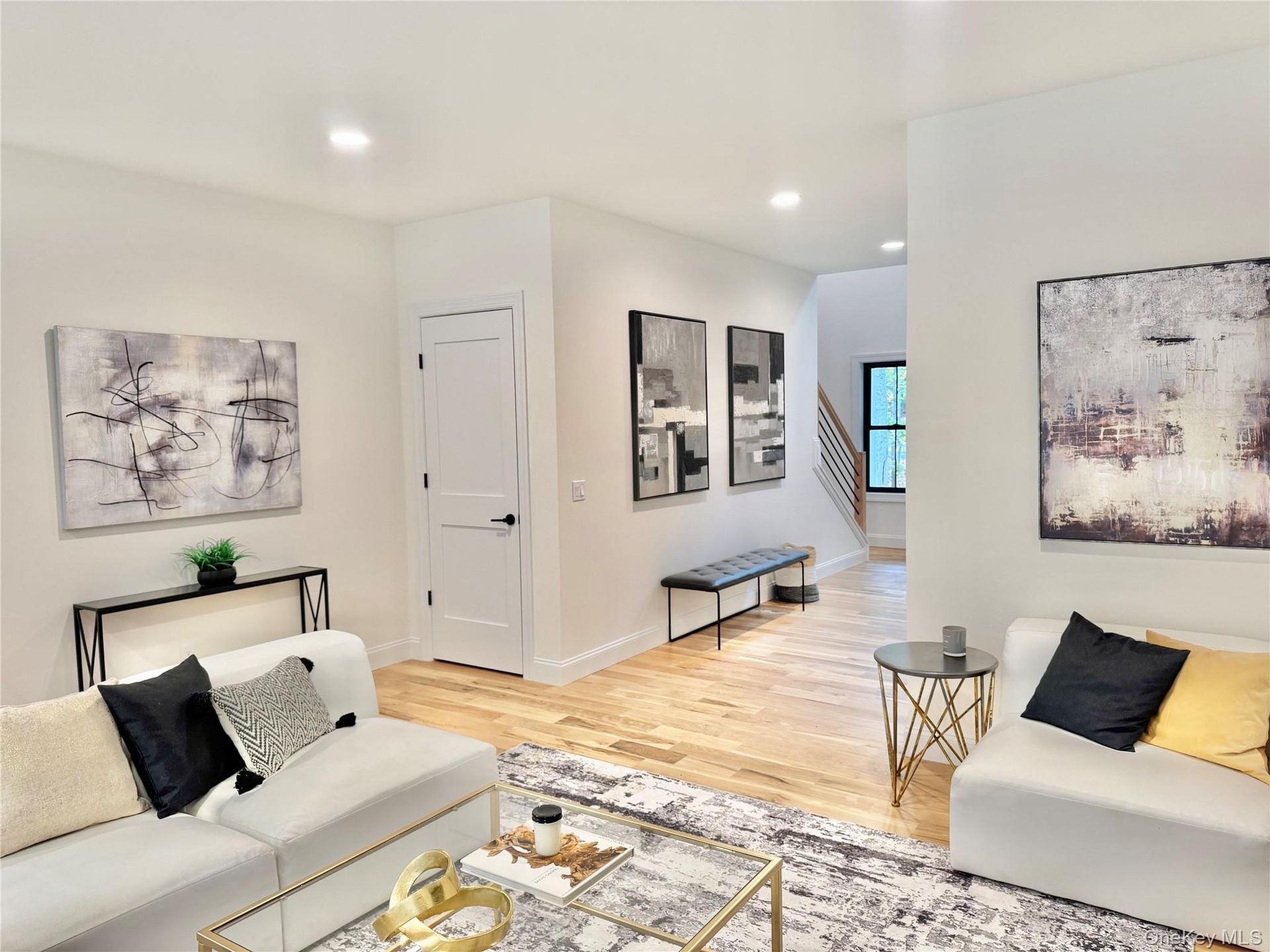 Living area featuring light wood-style flooring and recessed lighting