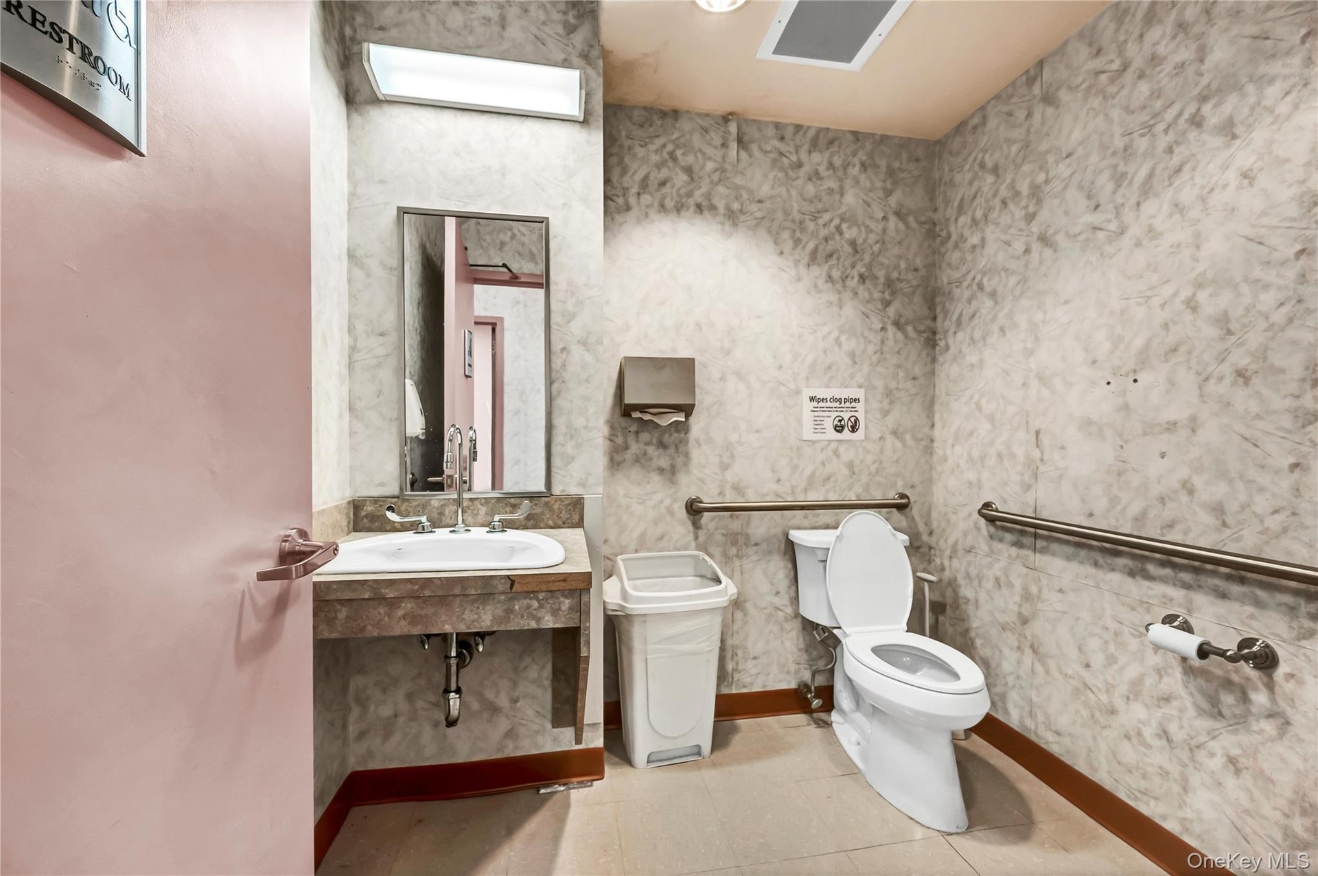 Bathroom featuring light tile patterned floors and vanity