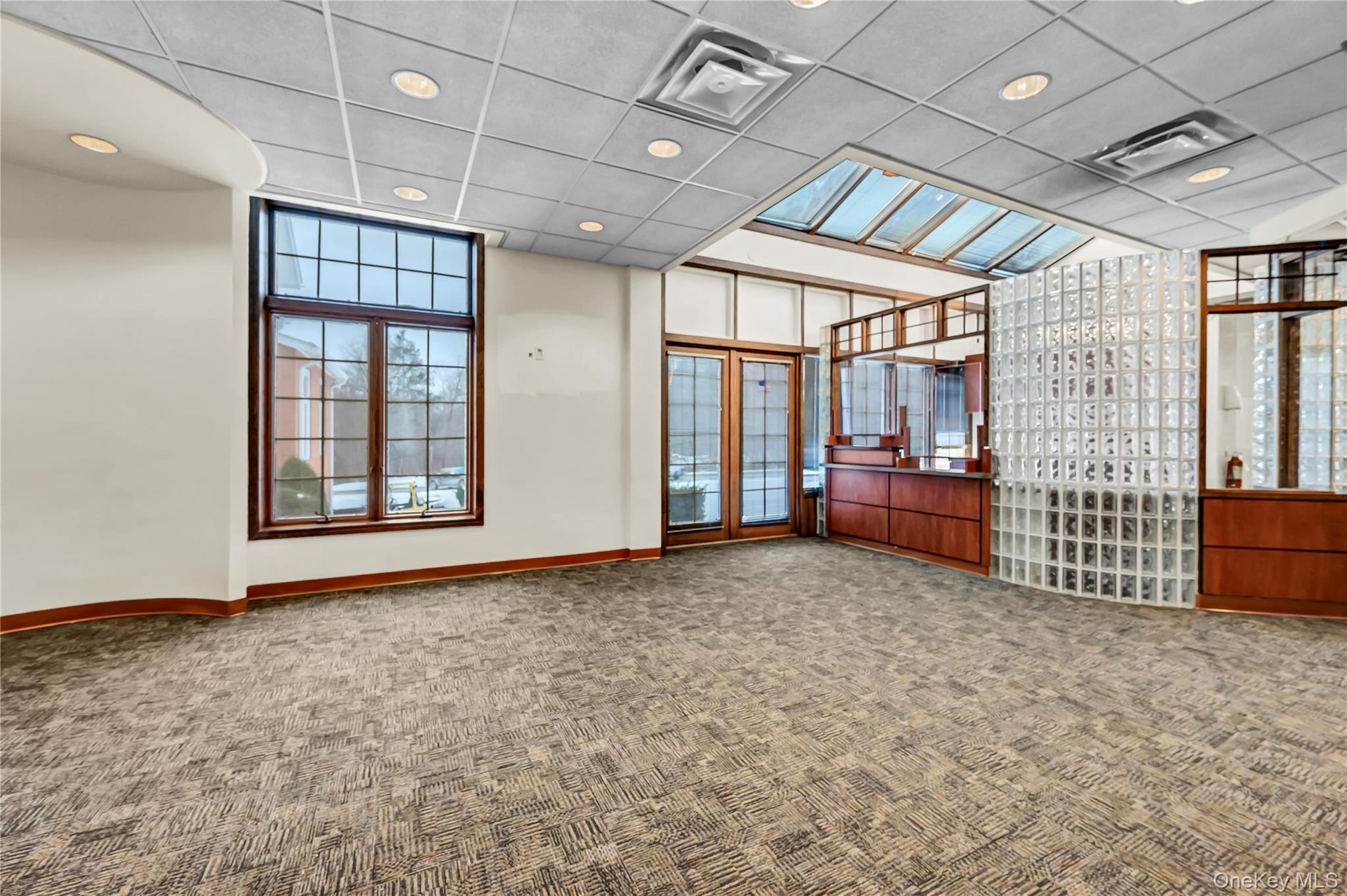 Unfurnished room with a drop ceiling, recessed lighting, and carpet